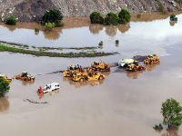 Floods engulf Queensland economy